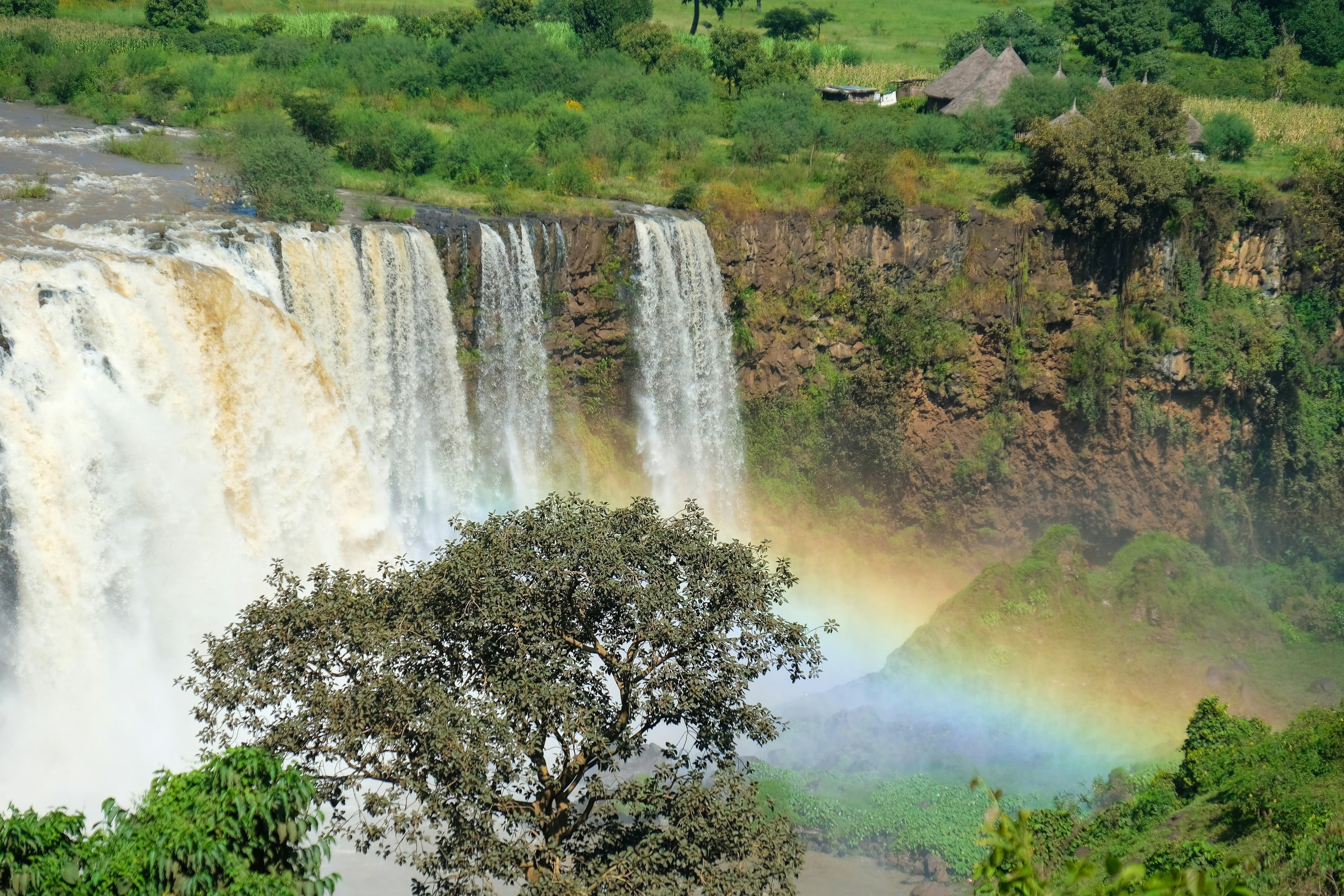 Ethiopian waterfall with rainbow and lush greenery